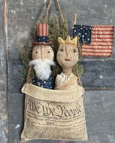 two cloth mice in a bag with the words we are people on it and an american flag