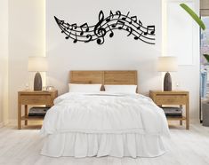 a bedroom with a bed, two nightstands and a musical note wall decal