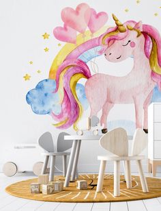 a child's room with a pink unicorn wall mural