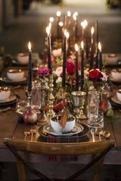 the table is set with candles and dishes