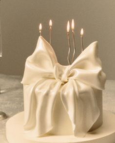 a white cake with three candles on it