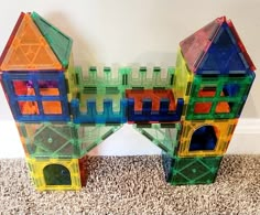 two plastic buildings sitting on top of a carpeted floor