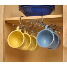 pots and pans are hanging on the rack