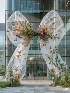 the entrance to an office building decorated with flowers and butterflies