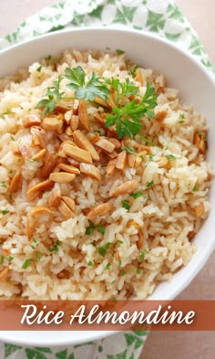 rice and almonds in a white bowl on a green napkin with the words rice almondine