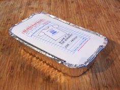 a piece of tin foil sitting on top of a wooden table