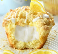 a muffin with lemons and marshmallows is on a paper plate