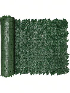 the green grass mat is rolled up and ready to be used as a wall decoration