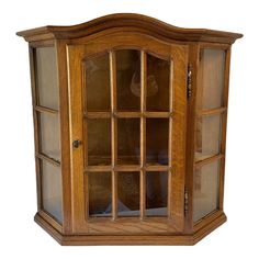 a wooden display case with glass doors on the front and back sides, in an oak finish