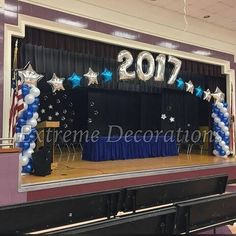 the stage is decorated with balloons and stars