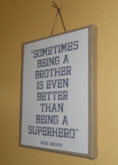 a sign hanging on the wall that says sometimes being a brother is even better than being a superhero