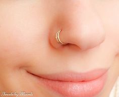 a close up of a person with a nose ring