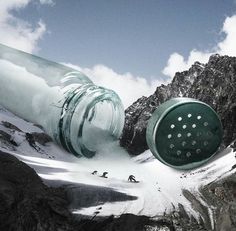 there is a large glass bottle in the middle of some snow covered mountain side area