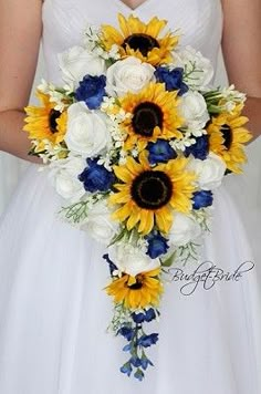 a bride holding a bouquet of sunflowers and white roses in her hands,