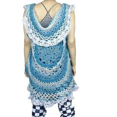 a woman wearing a blue and white crocheted dress