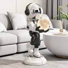 an astronaut figurine standing in front of a white couch