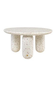 a white table with three pillars on it's legs and two small circles at the top