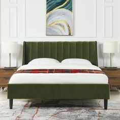 a bed with a green headboard sitting in a bedroom next to two nightstands