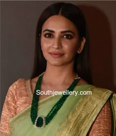 Kriti Kharbanda in a four line emerald beads mala with diamond emerald pendant. Emerald long chain models, emerald beads mala designs Beads Mala Designs, Emerald Beads Mala, Mala Designs, Necklaces Simple, Pure Gold Jewellery, Mala Jewelry, Clean Gold Jewelry