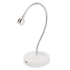 a desk lamp with a white base and a silver light on the top of it