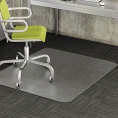 an office chair sitting on top of a hard wood floor next to a computer desk