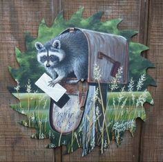 a painting of a raccoon in a mailbox on a wooden fence with grass and flowers