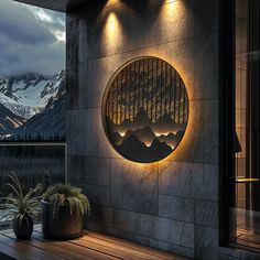 an outdoor area with mountains in the background and lights lit up on the outside wall