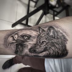 a man with a wolf tattoo on his arm and an eagle in the middle of his arm