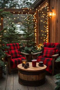 two chairs and a table on a deck with christmas lights