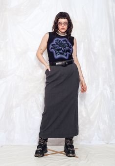 This Y2K vintage cargo maxi skirt is the ultimate Y2K throwback. Embrace the extra pockets, cosy vibes, and grey hue that will make you feel like you stepped straight out of a Men in Black movie--minus the aliens, of course. Recommended size: EU 42-44. Features: - three pockets - zip closure - 65% polyester, 32% viscose, 3% elastane - lined Every item we manage is cleaned and, when necessary, repaired, ensuring it arrives to you in top condition. Our model, Sawa is 170 cm / 66.3" tall and she's Black Film, Utility Skirt, Men In Black, Label Sizes, Y2k Vintage, Aliens, Hungary, Long Skirt, Vintage Y2k