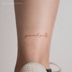 a woman's leg with the word strength tattooed on her left side ribcage