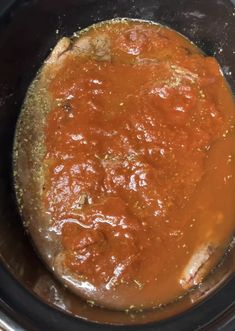 the sauce is being cooked in the slow cooker