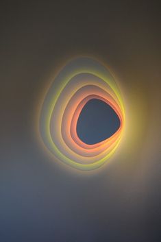 an abstract light painting with three circles in the middle and one circle at the top