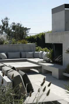 an outdoor seating area with couches and plants