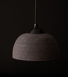 a black and grey lamp hanging from a ceiling