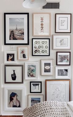 a wall filled with lots of framed pictures