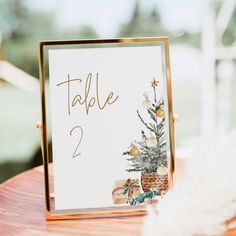 a table number with a christmas tree on it