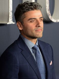 a man in a suit and tie looking off to the side