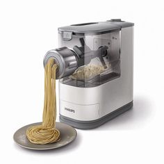 a pasta dispenser with noodles in it and a plate next to it