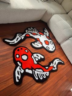 two rugs that have been placed next to each other on a wooden floor in front of a couch