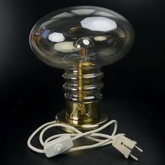 a lamp that is on top of a table with a cord attached to the base