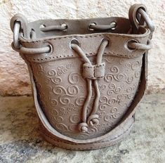 a brown purse sitting on top of a stone floor