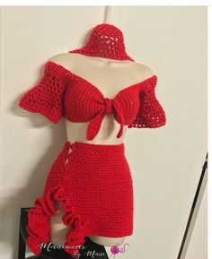 a red crochet dress and matching top is displayed on a mannequin