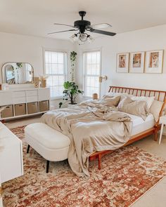 a bedroom with a bed, dresser and mirror