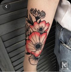 a woman's arm with red and black flowers on the left side of her arm