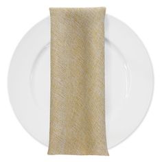 a white plate with a gold linen napkin on it