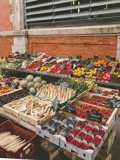 an assortment of fruits and vegetables on display at a farmers'market in the city