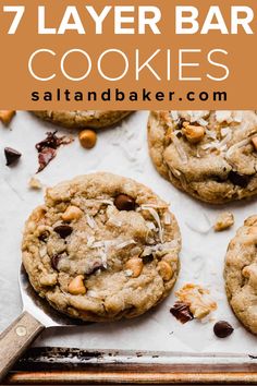 chocolate chip cookies on a baking sheet with text overlay that reads 7 layer bar cookies