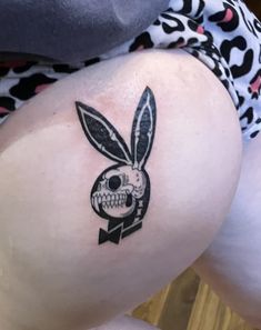 a person with a rabbit tattoo on their thigh