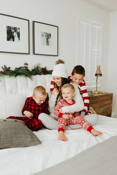 three children are sitting on the bed with their mother and two other kids in pajamas